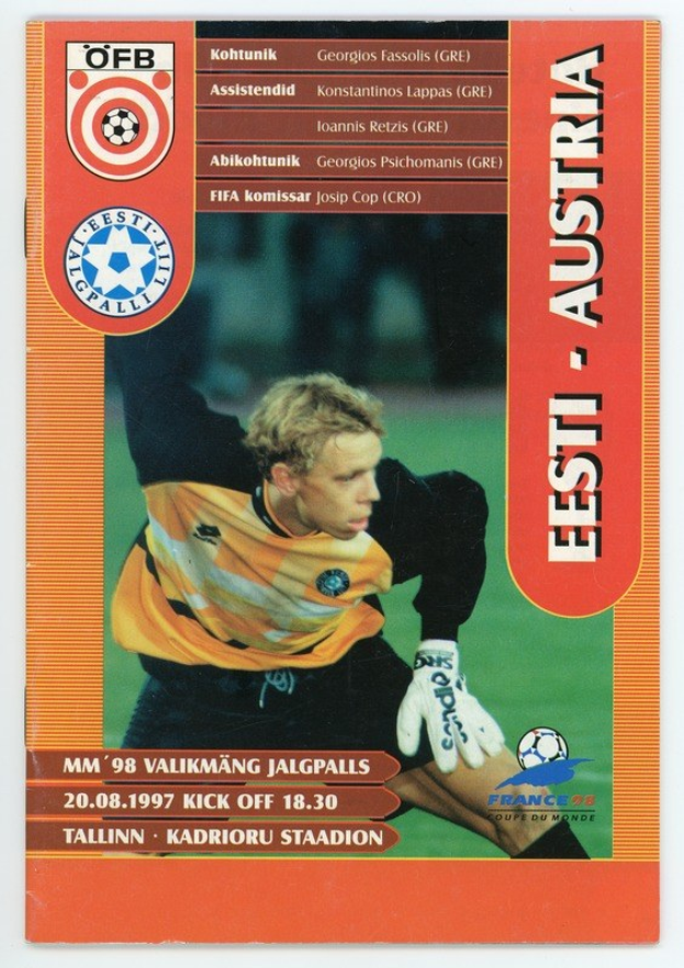 Soccer card from the 1998 FIFA World Cup featuring a player in a jersey with a determined expression, set against a bright blue sky with white clouds.
