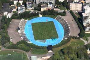Luftbild des Olympiastadions in München, Deutschland, umgeben von Stadtgebäuden, Bäumen, Straßen, Fahrzeugen und Gras.